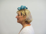 Long teardrop fascinator with leaves and ribbon with bead seeds