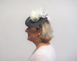 Small disc fascinator with ivory bows and ivory rose