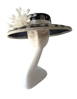 Black and ivory polka dot hatinator with ivory ribbon and ivory feather flower