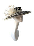 Black and ivory polka dot hatinator with ivory ribbon and ivory feather flower