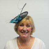 Small saucer fascinator with flower and spine