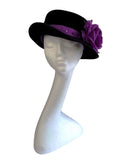 Black trilby with amethyst headband and pheasant feathers with purple rose