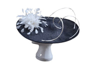 Large black saucer hatinator with ivory spirals and feather flower
