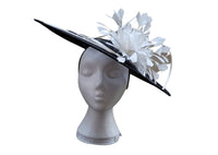 Large black saucer hatinator with ivory spirals and feather flower