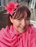 Soft sinamay concord fascinator with feathers and a brooch pin attachment.