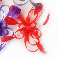 Crinoline looped fascinator with coq feathers on a clear comb