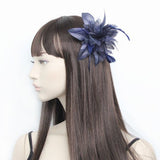 Flower fascinator with nettings and feathers on a clear comb.