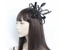 Crinoline looped fascinator with coq feathers on a clear comb