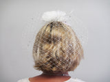 Diamante netting with feather flowers on a comb
