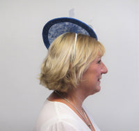 Disc fascinator with feather flowers and dalmonte netting