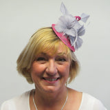 Lace covered fascinator base with feather flowers, feather arrow and swirls