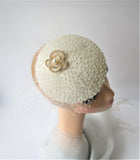 Bridal off white disc with pearls and netting with a brooch