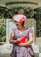 Red and white patterned small saucer with silk blossom flowers