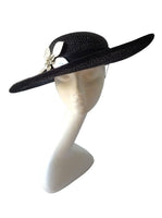 Black and silver upturned brim hatinator with silver leaver leaves and broach detail