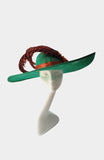 This beautiful emerald green hat with albaca band and amethyst pheasant feathers with a flower detail