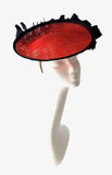 Small red saucer with navy edge and feather detail