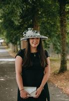 Black and ivory polka dot hatinator with ivory ribbon and ivory feather flower